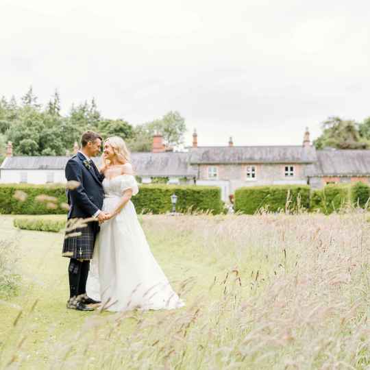 Wedding couple in the meadow grounds surrounding Virginia Park Lodge